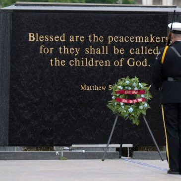 Families of two fallen Burnsville officers add their names to memorial flag