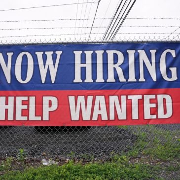 Fewer Americans sought unemployment benefits last week as layoffs remain low