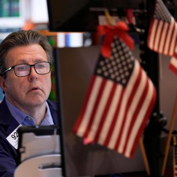 Wall Street hangs near records highs with most of the focus on earnings, dealmaking