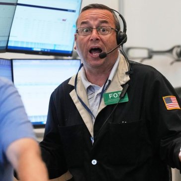 Stocks tick higher as Wall Street drifts near its record levels