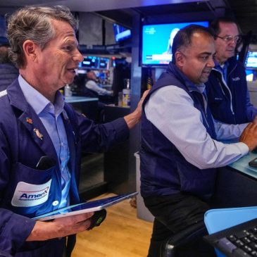 Wall Street rises and pulls close to its record