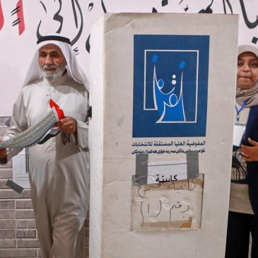 Iraqis vote in a parliamentary election marked by tight security and a major political boycott