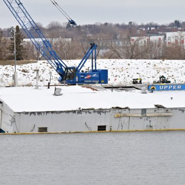 Maintenance barge on the Mississippi River is partially submerged