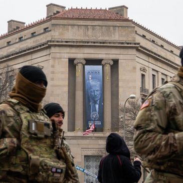 Large banner featuring Trump’s face is displayed on Justice Department headquarters